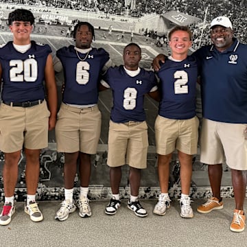 Holy Trinity Episcopal coach Hurlie Brown (far right), a former two-national champion as a player at Miami, will lead the Tigers into the Sunshine State Athletic Association this season.