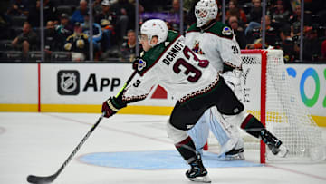 Oct 5, 2023; Anaheim, California, USA; Arizona Coyotes defenseman Travis Dermott (33) clears the puck against the Anaheim Ducks during the second period at Honda Center. Mandatory Credit: Gary A. Vasquez-Imagn Images