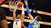 Dec 14, 2024; Phoenix, Arizona, USA; Arizona Wildcats forward Trey Townsend (4) dunks the ball against UCLA Bruins forward Tyler Bilodeau (34) in the first half at Footprint Center. Mandatory Credit: Mark J. Rebilas-Imagn Images