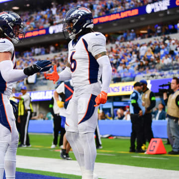 Dec 10, 2023; Inglewood, California, USA; Denver Broncos safety P.J. Locke (6) celebrates with linebacker Alex Singleton (49) after stopping a scoring chance by Los Angeles Chargers tight end Gerald Everett (7)  during the first half at SoFi Stadium. Mandatory Credit: Gary A. Vasquez-USA TODAY Sports