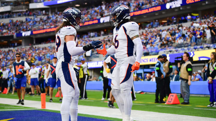 Dec 10, 2023; Inglewood, California, USA; Denver Broncos safety P.J. Locke (6) celebrates with linebacker Alex Singleton (49) after stopping a scoring chance by Los Angeles Chargers tight end Gerald Everett (7)  during the first half at SoFi Stadium. Mandatory Credit: Gary A. Vasquez-USA TODAY Sports