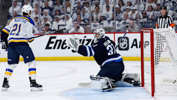 Apr 19, 2025; Winnipeg, Manitoba, CAN; St. Louis Blues forward Robert Thomas (18) (not shown) scores on Winnipeg Jets goalie Connor Hellebuyck (37) during the first period in game one of the first round of the 2025 Stanley Cup Playoffs at Canada Life Centre. Mandatory Credit: Terrence Lee-Imagn Images