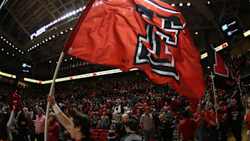 Jan 31, 2018; Lubbock, TX, USA; A Texas Tech Red Raiders cheerleader brings the team flag onto the court before the game against the Texas Longhorns at United Supermarkets Arena. Mandatory Credit: Michael C. Johnson-Imagn Images