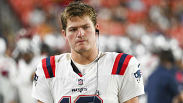 Aug 25, 2024; Landover, Maryland, USA;  New England Patriots quarterback Drake Maye (10) stands in the bench area during the second  half against the Washington Commanders at Commanders Field. Mandatory Credit: Tommy Gilligan-Imagn Images