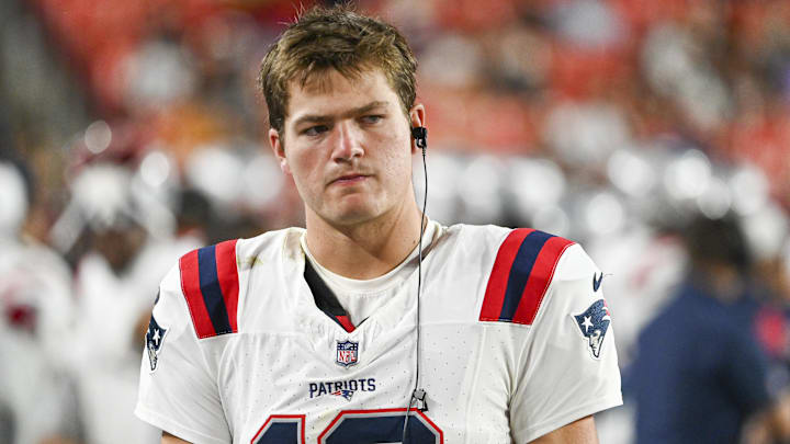 Aug 25, 2024; Landover, Maryland, USA;  New England Patriots quarterback Drake Maye (10) stands in the bench area during the second  half against the Washington Commanders at Commanders Field. Mandatory Credit: Tommy Gilligan-Imagn Images