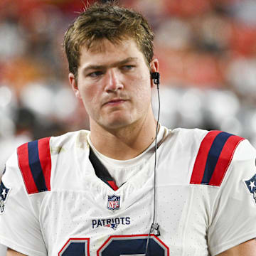 Aug 25, 2024; Landover, Maryland, USA;  New England Patriots quarterback Drake Maye (10) stands in the bench area during the second  half against the Washington Commanders at Commanders Field.