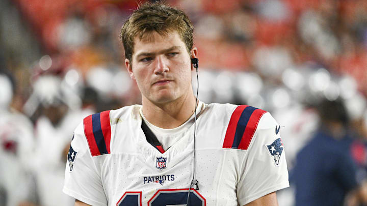 Aug 25, 2024; Landover, Maryland, USA;  New England Patriots quarterback Drake Maye (10) stands in the bench area during the second  half against the Washington Commanders at Commanders Field.