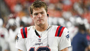 New England Patriots quarterback Drake Maye (10) stands in the bench area during the second  half at Commanders Field.