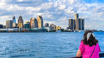 A female tourist looking at the Detroit cityscape or skyline...