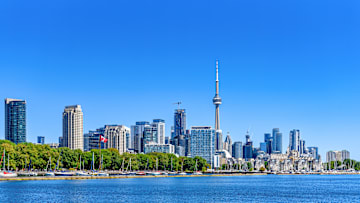 Cityscape and downtown district on a clear blue sky day,...
