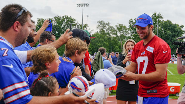 Buffalo Bills quarterback Josh Allen (17) signs autographs for fans during training camp