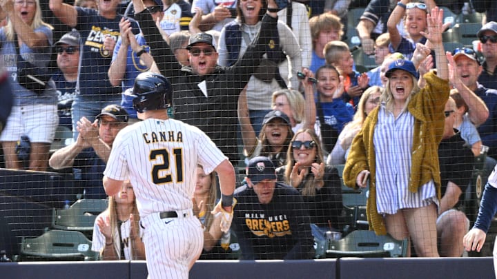 Sep 17, 2023; Milwaukee, Wisconsin, USA; Milwaukee Brewers fans celebrate as Milwaukee Brewers left fielder Mark Canha (21) scores a run against the Washington Nationals in the sixth inning at American Family Field. Mandatory Credit: Michael McLoone-Imagn Images