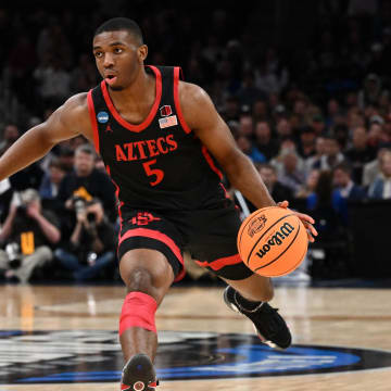 Mar 28, 2024; Boston, MA, USA; San Diego State Aztecs guard Lamont Butler (5) dribbles the ball against the Connecticut Huskies in the semifinals of the East Regional of the 2024 NCAA Tournament at TD Garden. Mandatory Credit: Brian Fluharty-USA TODAY Sports
