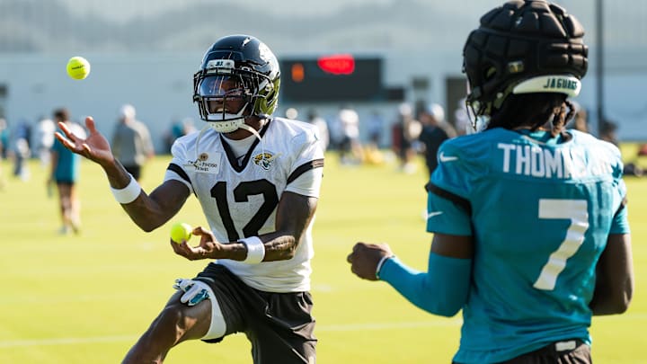 Jacksonville Jaguars wide receivers Travis Hunter and Brian Thomas Jr. use tennis balls in a NFL training camp session