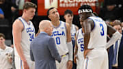 Dec 28, 2024; Inglewood, California, USA; UCLA Bruins head coach Mick Cronin talks to Tyler Bilodeau (34), Kobe Johnson (0), Dylan Andrews (2) and Eric Dailey Jr. (3) in the first half against the Gonzaga Bulldogs during a college basketball game at Intuit Dome. Mandatory Credit: Robert Hanashiro-Imagn Images
