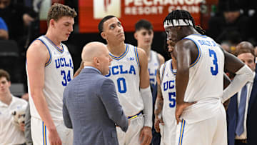 Dec 28, 2024; Inglewood, California, USA; UCLA Bruins head coach Mick Cronin talks to Tyler Bilodeau (34), Kobe Johnson (0), Dylan Andrews (2) and Eric Dailey Jr. (3) in the first half against the Gonzaga Bulldogs during a college basketball game at Intuit Dome. Mandatory Credit: Robert Hanashiro-Imagn Images