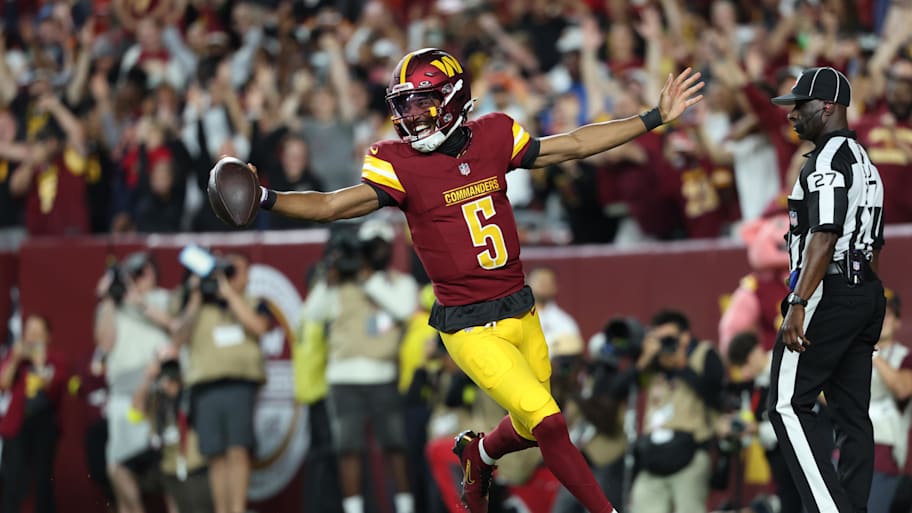 Washington Commanders quarterback Jayden Daniels celebrates after scoring a touchdown against Cincinnati Bengals. | Amber Searls-Imagn Images