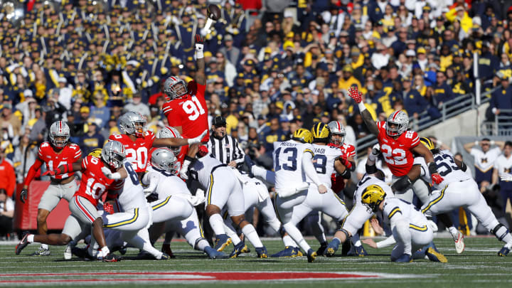 Nov 26, 2022; Columbus, Ohio, USA; Michigan Wolverines place kicker Jake Moody (13) kicks the ball as Ohio State Buckeyes defensive tackle Tyleik Williams (91) goes for the block during the first quarter at Ohio Stadium. Mandatory Credit: Joseph Maiorana-USA TODAY Sports