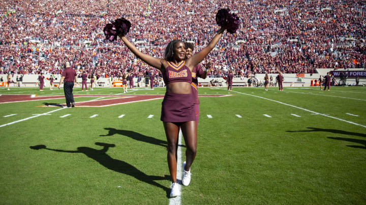 Oct 14, 2023; Blacksburg, Virginia, USA; A cheerleader cheers on the field before the game between the Virginia Tech Hokies and the Wake Forest Demon Deacons at Lane Stadium. Mandatory Credit: Peter Casey-USA TODAY Sports