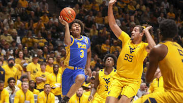 Nov 13, 2025; Morgantown, West Virginia, USA; Pittsburgh Panthers guard Brandin Cummings (3) shoots over West Virginia Mountaineers center Harlan Obioha (55) during the first half at WVU Coliseum. Mandatory Credit: Ben Queen-Imagn Images