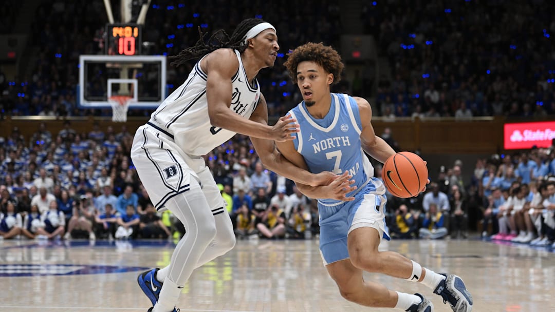 Feb 1, 2025; Durham, North Carolina, USA;  North Carolina Tar Heels guard Seth Trimble (7) drives the ball around Duke Blue Devils forward Maliq Brown (6) during the first half at Cameron Indoor Stadium. Mandatory Credit: Zachary Taft-Imagn Images