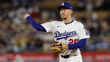 Apr 28, 2025; Los Angeles, California, USA; Los Angeles Dodgers second baseman Tommy Edman (25) throws to first for an out during the tenth inning against the Miami Marlins at Dodger Stadium. Mandatory Credit: Jason Parkhurst-Imagn Images