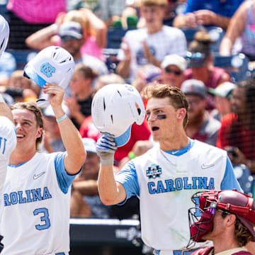 Jun 18, 2024; Omaha, NE, USA; North Carolina Tar Heels center fielder Vance Honeycutt (7) celebrates with second baseman Alex Madera (1), shortstop Colby Wilkerson (3) and first baseman Parks Harber (14) after hitting a three-run home run against the Florida State Seminoles during the fifth inning at Charles Schwab Field Omaha. 
