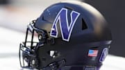 Nov 11, 2023; Madison, Wisconsin, USA;  General view of a Northwestern Wildcats helmet on the sidelines during the game against the Wisconsin Badgers at Camp Randall Stadium. Mandatory Credit: Jeff Hanisch-Imagn Images