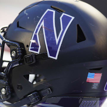 Nov 11, 2023; Madison, Wisconsin, USA;  General view of a Northwestern Wildcats helmet on the sidelines during the game against the Wisconsin Badgers at Camp Randall Stadium. Mandatory Credit: Jeff Hanisch-Imagn Images