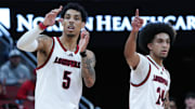 Louisville guard Terrence Edwards Jr. (5) and guard Chucky Hepburn (24) watch a teammate shoot free throws against California during their game at the KFC Yum! Center in Louisville, Ky. on Mar. 5, 2025.