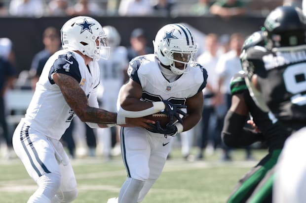 Dallas Cowboys quarterback Dak Prescott hands off to running back Javonte Williams against the New York Jets. 