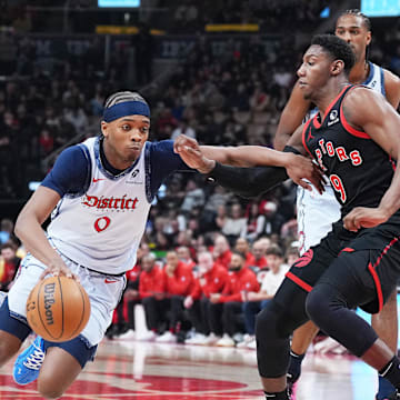 Mar 8, 2025; Toronto, Ontario, CAN;  Washington Wizards guard Bilal Coulibaly (0) controls the ball as Toronto Raptors guard RJ Barrett (9) tries to defend during the first quarter at Scotiabank Arena. Mandatory Credit: Nick Turchiaro-Imagn Images