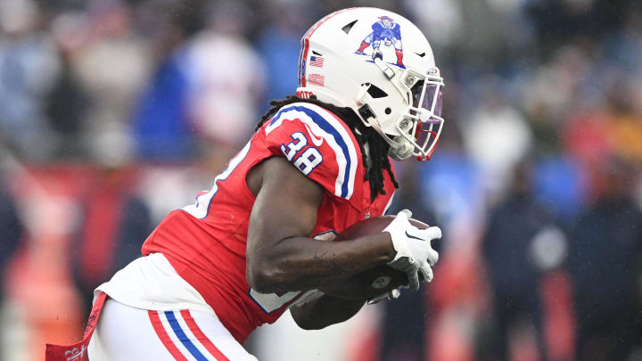 Dec 3, 2023; Foxborough, Massachusetts, USA; New England Patriots running back Rhamondre Stevenson (38) rushes against the Los Angeles Chargers during the first half at Gillette Stadium.