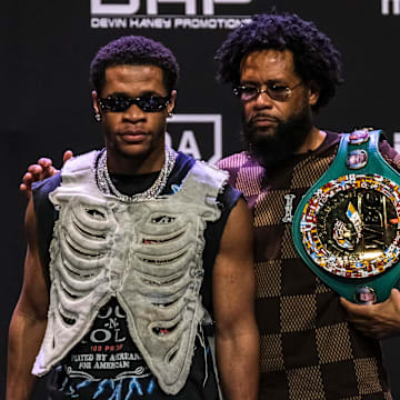 WBC Super Lightweight Champion Devin Haney and his father trainer Bill Haney stand on stage on February 29, 2024.