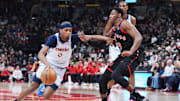 Mar 8, 2025; Toronto, Ontario, CAN;  Washington Wizards guard Bilal Coulibaly (0) controls the ball as Toronto Raptors guard RJ Barrett (9) tries to defend during the first quarter at Scotiabank Arena. Mandatory Credit: Nick Turchiaro-Imagn Images