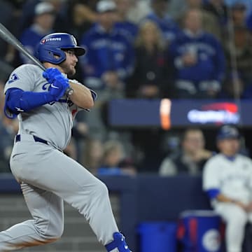 Nov 1, 2025; Toronto, Ontario, CAN; Los Angeles Dodgers third baseman Max Muncy (13) hits a single against the Toronto Blue Jays in the tenth inning during game seven of the 2025 MLB World Series at Rogers Centre. Mandatory Credit: John E. Sokolowski-Imagn Images