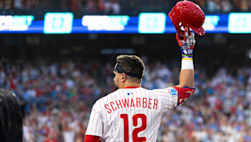 Jul 19, 2025; Philadelphia, Pennsylvania, USA; Philadelphia Phillies outfielder Kyle Schwarber (12) comes out of the dugout for a curtin call after his grand slam during the sixth inning against the Los Angeles Angels at Citizens Bank Park. Mandatory Credit: Bill Streicher-Imagn Images