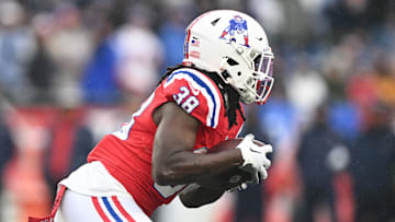 Dec 3, 2023; Foxborough, Massachusetts, USA; New England Patriots running back Rhamondre Stevenson (38) rushes against the Los Angeles Chargers during the first half at Gillette Stadium. Mandatory Credit: Brian Fluharty-USA TODAY Sports