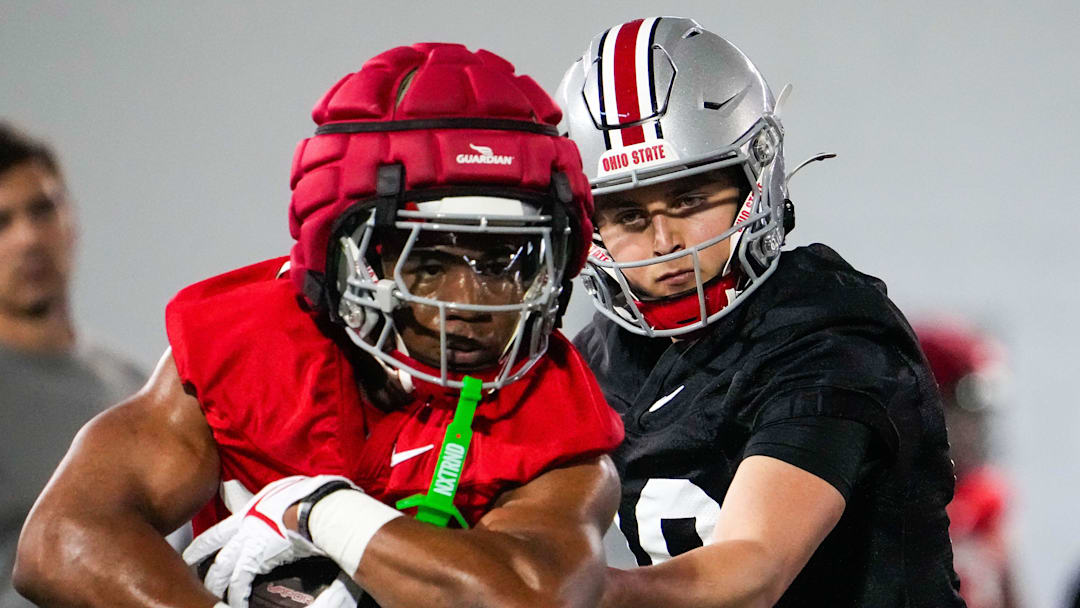 Ohio State Buckeyes quarterbacks Julian Sayin (10) hands the ball off to running back James Peoples (20) during spring football practice at the Woody Hayes Athletic Center on Wednesday, March 19, 2025 in Columbus, Ohio.