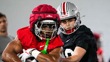 Ohio State Buckeyes quarterbacks Julian Sayin (10) hands the ball off to running back James Peoples (20) during spring football practice at the Woody Hayes Athletic Center on Wednesday, March 19, 2025 in Columbus, Ohio.