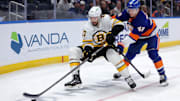 Nov 4, 2025; Elmont, New York, USA; New York Islanders defenseman Matthew Schaefer (48) cross checks Boston Bruins center Mark Kastelic (47) during the third period at UBS Arena. A penalty was called on Schaefer for the hit. Mandatory Credit: Brad Penner-Imagn Images