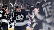 Nov 9, 2024; Los Angeles, California, USA; Los Angeles Kings left wing Trevor Moore (12) celebrates with teammates after scoring during the third period against the Columbus Blue Jackets at Crypto.com Arena. Mandatory Credit: Jason Parkhurst-Imagn Images
