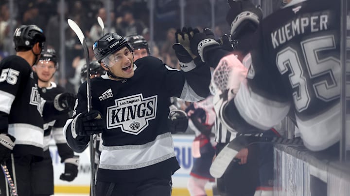 Nov 9, 2024; Los Angeles, California, USA; Los Angeles Kings left wing Trevor Moore (12) celebrates with teammates after scoring during the third period against the Columbus Blue Jackets at Crypto.com Arena. Mandatory Credit: Jason Parkhurst-Imagn Images