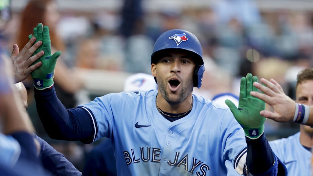 Jul 26, 2025; Detroit, Michigan, USA;  Toronto Blue Jays outfielder George Springer (4) receives congratulations from teammates after he hits a home run in the ninth inning against the Detroit Tigers at Comerica Park. 