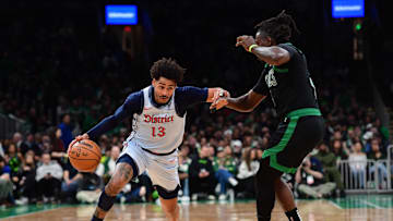 Apr 6, 2025; Boston, Massachusetts, USA; Washington Wizards guard Jordan Poole (13) controls the ball while Boston Celtics guard Jrue Holiday (4) defends during the first half at TD Garden. Mandatory Credit: Bob DeChiara-Imagn Images