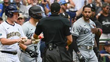 Chicago White Sox left fielder Tommy Pham (28) is restrained by umpires after exchanging words with Milwaukee Brewers catcher William Contreras in the eighth inning at American Family Field.
