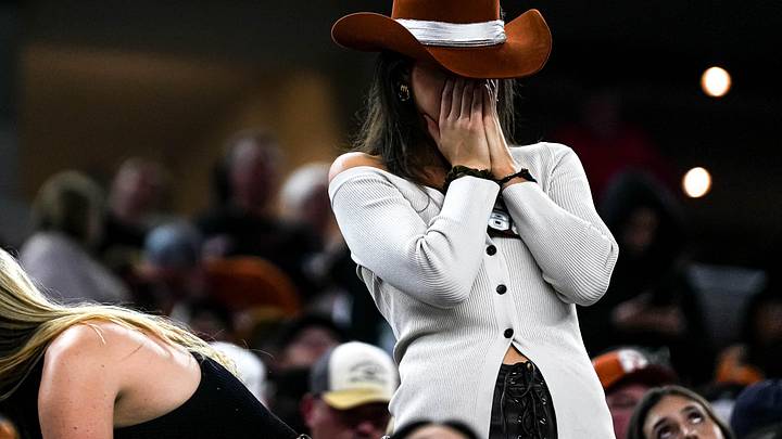 A Texas Longhorns fan reacts to a turnover on 4th and goal during the College Football Playoff semifinal game against Ohio State in the Cotton Bowl at AT&T Stadium on Friday, Jan. 10, 2024 in Arlington, Texas.