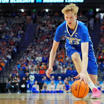 Mar 22, 2025; Lexington, KY, USA;  Creighton Bluejays forward Jackson McAndrew (23) picks up a loose ball during the first half against the Auburn Tigers in the second round to the NCAA Tournament at Rupp Arena.