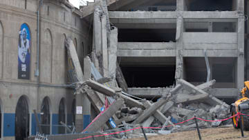 Large concrete beams supporting parts of David Booth Kansas Memorial Stadium are torn down