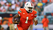Sep 7, 2024; Miami Gardens, Florida, USA; Miami Hurricanes quarterback Cam Ward (1) runs with the football against the Florida A&M Rattlers during the second quarter at Hard Rock Stadium. Mandatory Credit: Sam Navarro-Imagn Images
